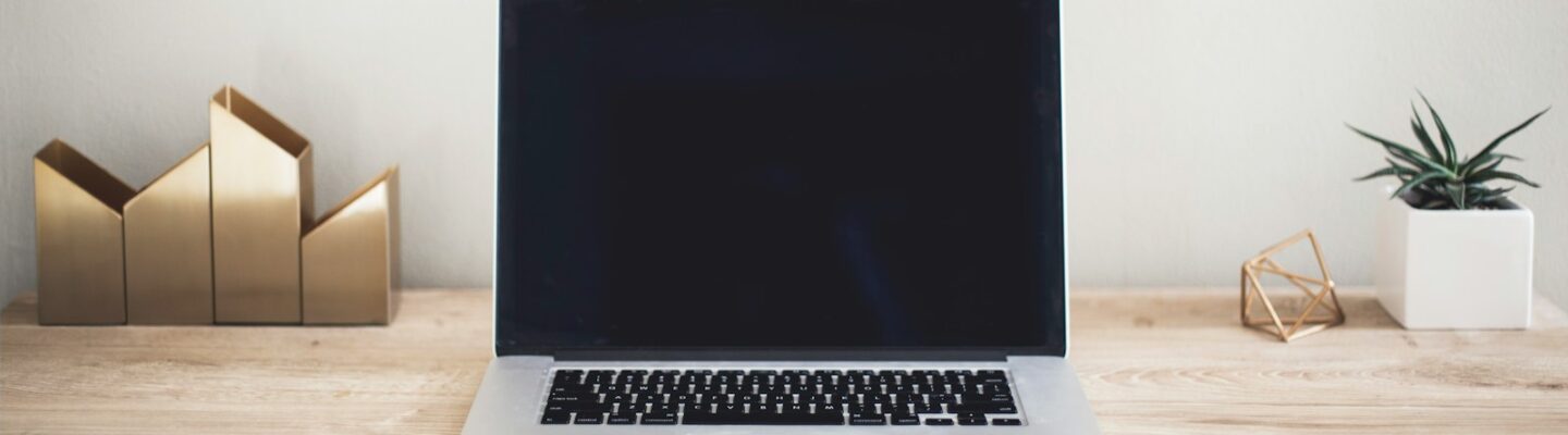 MacBook Pro on top of brown table