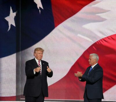 Donald Trump beside man in black suit