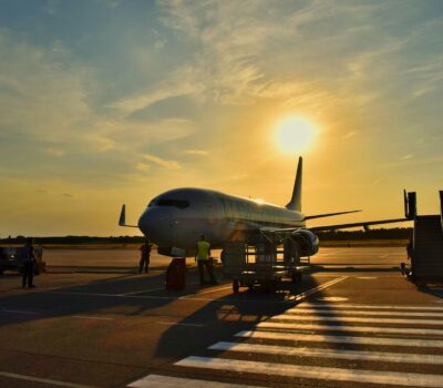 white airplane parked during daytime