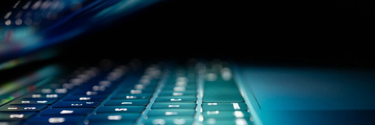 closeup photo of turned-on blue and white laptop computer