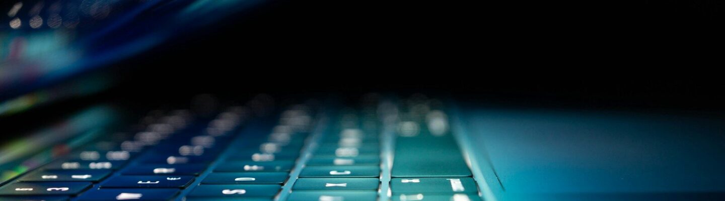 closeup photo of turned-on blue and white laptop computer