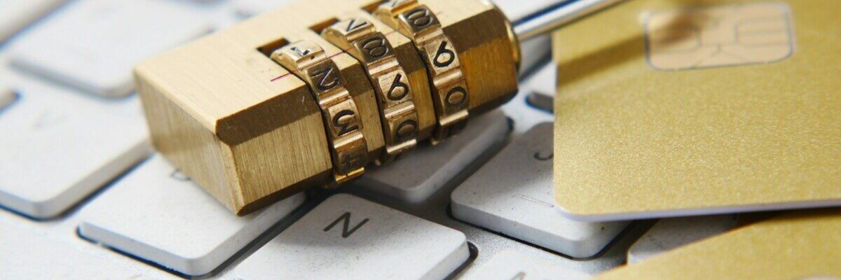 a golden padlock sitting on top of a keyboard
