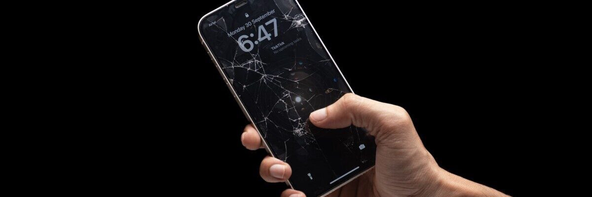 A person holding a cell phone in their hand