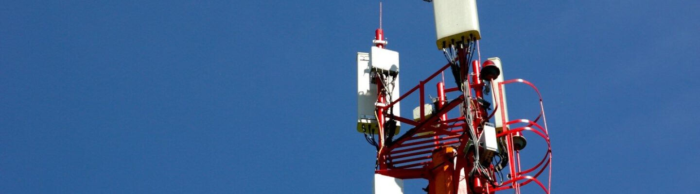 A cell phone tower with a blue sky in the background