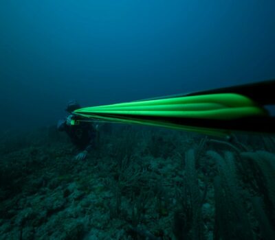 a man in a wet suit is diving in the ocean