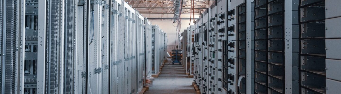server room aisle with metal equipment racks
