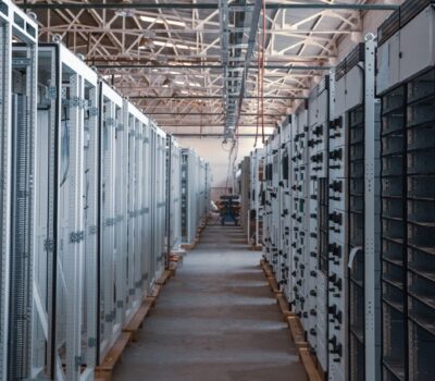 server room aisle with metal equipment racks