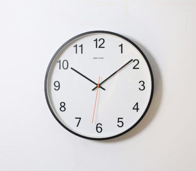 round analog wall clock pointing at 10:09