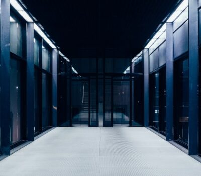 a long hallway with glass doors leading to another room